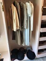 Group shot of coats hanging and hats below