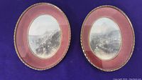Two oval framed steel engravings side by side, red matte and gold beaded inner border, coastal landscape scenes