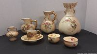 Overview of all items including three vases, teacup and saucer, two lidded bowls