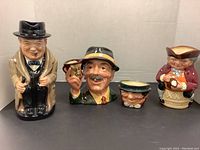 Four Royal Doulton Toby mugs/figurines including Winston Churchill, Tony Weller sugar bowl, Toby XX pitcher and mug.