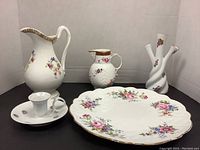 Group photo showing all items: Coalport pitcher, small pitcher, three-armed twisted vase, candle holder, and Aynsley floral plate