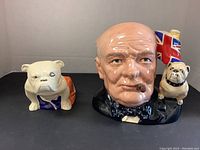 Front view of both pieces showing Churchill jug with bulldog handle and separate bulldog figurine