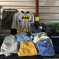 Full lot view: Timberland boots, Batman sweatshirt, various boys clothing including shirts, shorts, pants, Abercrombie sweatshirt, Aeropostale cap