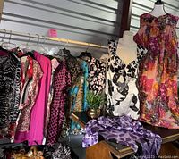 Photo showing rack of ladies plus size clothing including brightly colored floral and animal print dresses and jackets