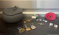 Photo of assorted men's jewelry including pins, cufflinks, key chains, a woven basket and a Hallmark ornament