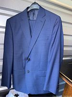 Blue Kenneth Cole stretch suit jacket size 44R hanging on hanger