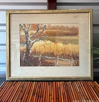 Framed watercolor autumn landscape print with tree and fence in worn gold frame