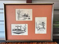 Framed display of three pencil drawings by Al Richardson on orange background mat.