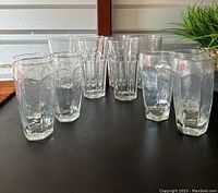 Full set of 12 drinking glasses arranged on table, 6 heavy Duratuff, 6 lighter glasses in rear, also packing box visible