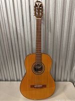 Full front view of the Epiphone Pro 1 Classic guitar showing the natural wood finish and classical guitar shape.