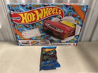 Photo of Hot Wheels Celebration Box with included mystery car pack in front