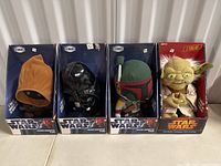 Four Star Wars talking plush characters in box: Ewok, Darth Vader, Boba Fett, Yoda