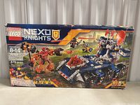 Front of the LEGO NEXO Knights box showing set art of vehicle and monster with branding and piece count.