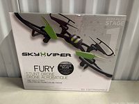 Front box photo showing the Sky Viper Fury stunt drone in black and green with branding and key features visible.