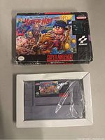 Front view of the SNES game cartridge and original box with cover art for Legend Of The Mystical Ninja by Konami.