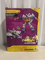Rear view of the box showing Starscream in robot and jet forms with Seeker Strike branding and transformation info.