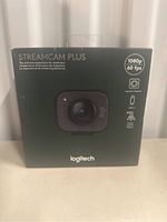 Front of Logitech StreamCam Plus box showing product image and key features like 1080p resolution and 60fps.