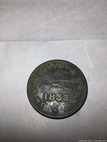 Obverse side of the coin showing a plow, the year 1833, and inscriptions.