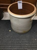 Front view of the 3 gallon crock showing the glazed brown interior and beige exterior with slight discoloration near the base.
