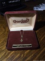 Gold filled necklace with pendant and diamond inside Gordon's Jewelers box.