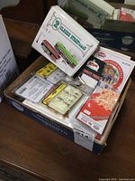 Boxed lot with multiple packages of HO scale models including streetcars and figures