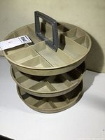 Side perspective showing all three tiers and central handle