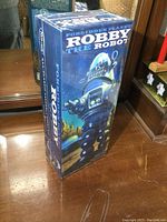 Sealed box of Robby The Robot model from Forbidden Planet showing front and sides with detailed graphics and text.