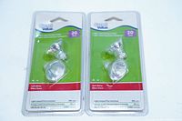 Two packages each containing two MR11 GU4 20W halogen light bulbs from Great Value, sealed in blister packs with green and white labeling.