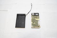 Photo showing Sharp EL-8118 calculator in its original box next to a black carrying case with a wrist strap.