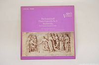 Front of album cover showing lavender background with an artistic classical depiction and album title text.