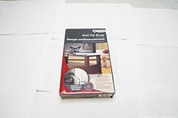 Boxed Mount-It! anti-tip safety strap kit with red and black packaging showing product use and features.