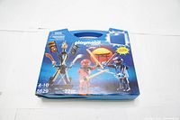 Front view of the Playmobil 5629 Knights Ninjas case in blue packaging with clear handle and visible contents illustration showing two figures and accessories.