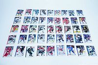 Top-down photo of 45 hockey cards arranged in five rows, showing a variety of NHL players and teams in action or posed shots on front of cards.