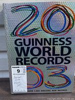 Front cover of 2003 Guinness World Records book showing holographic and colorful design with large numerals and text.