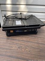 Side and top view of the Torque Master XT tile cutter showing its compact design and attached power cord.