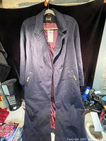 Full front view of the navy blue ladies wool coat showing button details and length