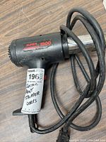 Photo of the Super Stripper 1500 electric paint stripper showing the label, cord, and grip.