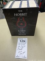 Photo showing all four books in a black slipcase labeled The Hobbit The Lord of the Rings with a red emblem