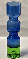 Front view of the 1970s Aseda Swedish glass vase showing the blue upper sections and green bottom base with smooth glass surface.