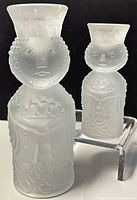 Photo of two vintage frosted glass wise man candleholders, one 6-inch and one 4-inch, with intricate facial and robe details.