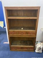 Front view of antique Japanese Mizuya cabinet showing two sections with shelves and multiple drawers.