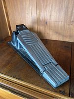 Roland FD-6 drum pedal showing top pedal surface and side profile, placed on wooden surface.