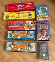 Top view of boxed baseball card collector sets from various brands and years, mostly sealed.