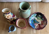 Lot overview showing all five ceramic items: large painted bowl on the right, green Frankoma vase in center, Royal Doulton character mug on left, Chip 'n Dale peanut mug below it, and small planter pot in front.