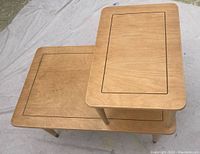 Top view showing two wooden side tables with inset rectangular groove