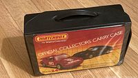 Black plastic Matchbox Official Collectors Carry Case for 24 vehicles featuring red and black sports cars on label