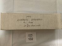 Side view of the white long box containing the 1992 Donruss Baseball card set with handwritten text indicating set number range and bonus cards.