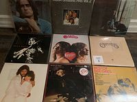 Assortment of nine 1970s vinyl record album covers featuring popular artists of the era.