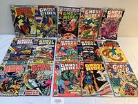 Full view of 14 Ghost Rider comic books arranged on a white surface, showing various cover art and issue numbers.