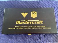 Closed black presentation case with gold Mastercraft logo and limited edition 90 year badge.